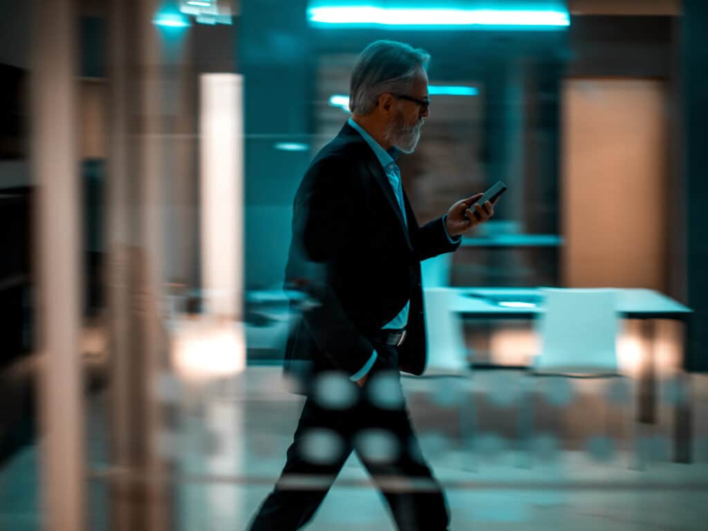 Businessman talking on phone while walking