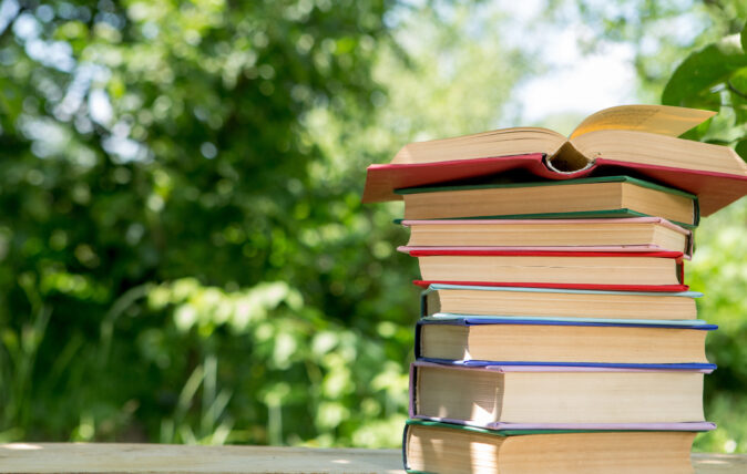 Book stack with trees in background