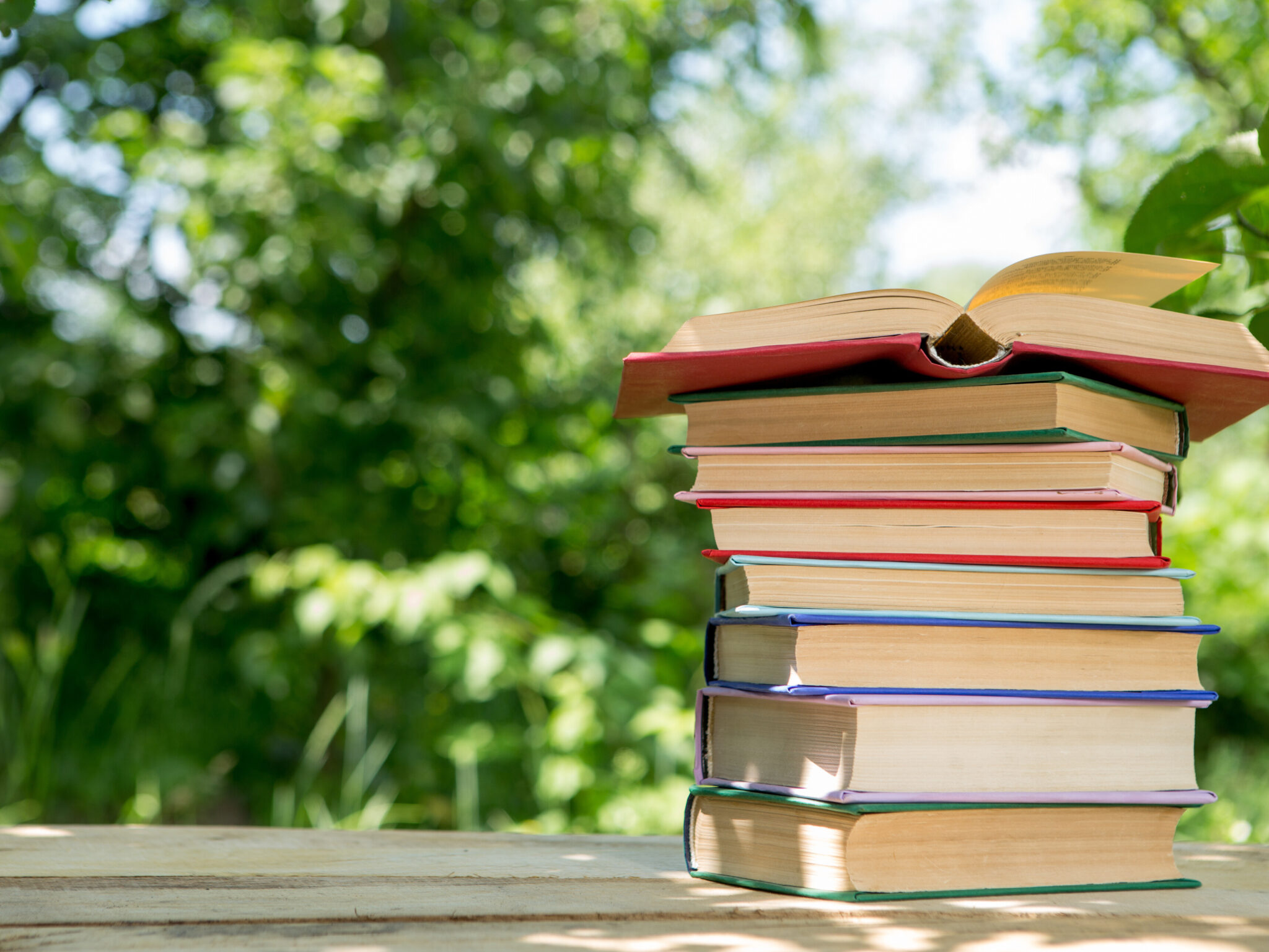 Book stack with trees in background