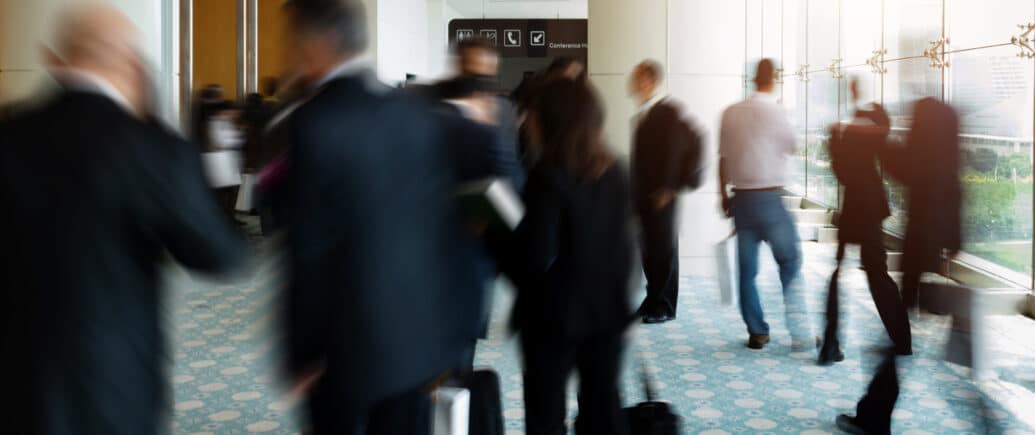 Event attendees congregate in a hallway