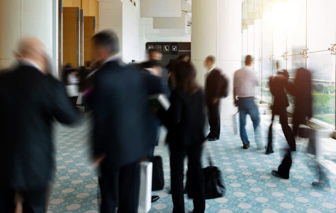 Event attendees congregate in a hallway
