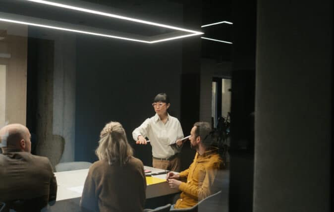 Group meeting in a dimly lit conference room