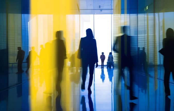 View of people walking through glass